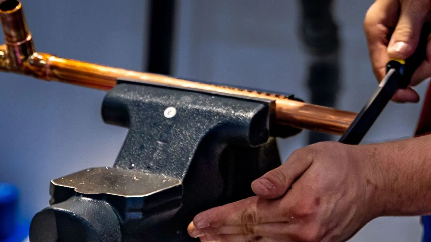 Copper pipe clamped in a vise for bending