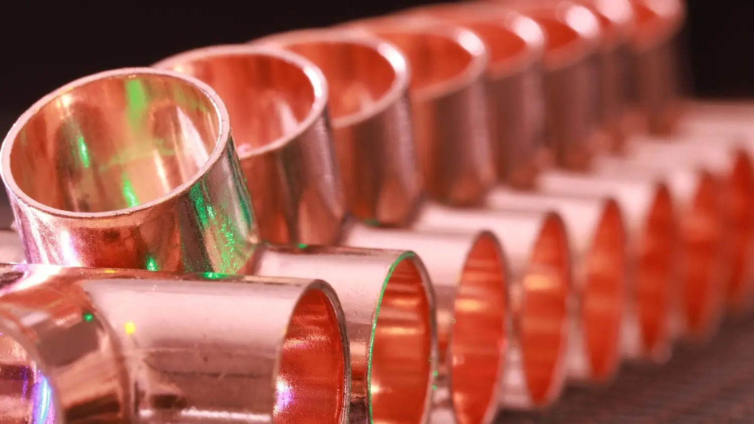Copper plumbing fittings lined up in a row